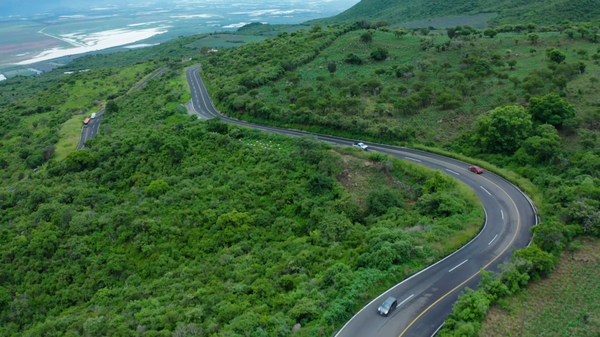 高清视频素材Curvy road on a tree covered hill